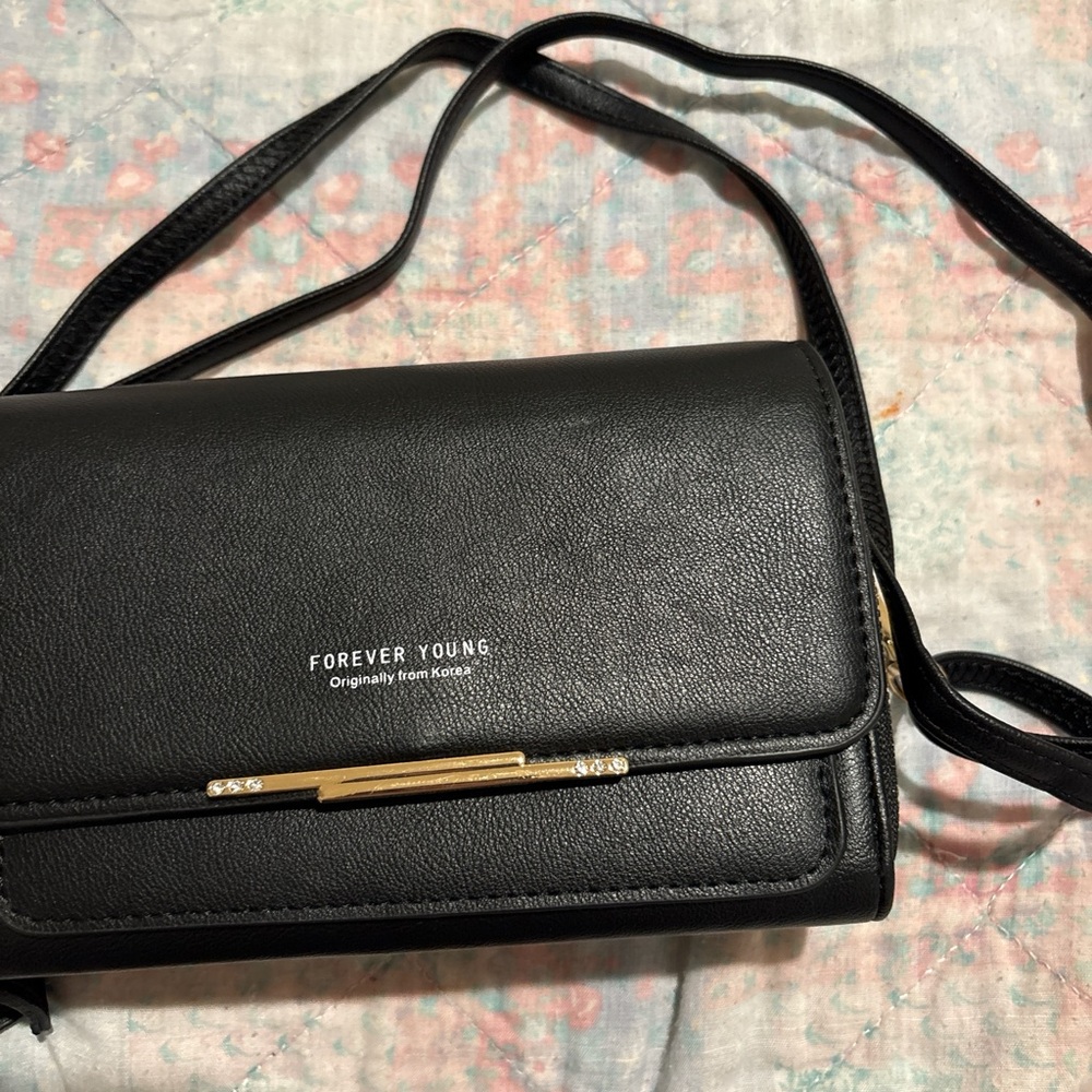 Black and gold bag can be used as a crossed body bag.